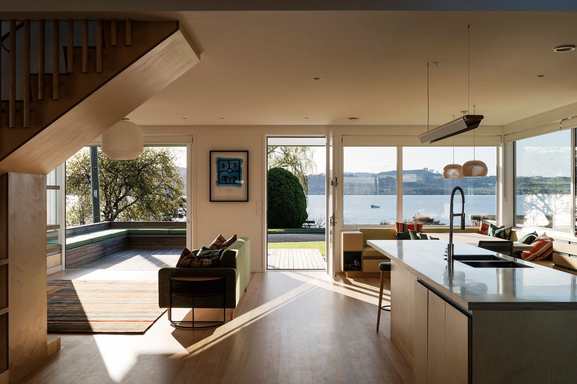 The interior living, kitchen, and dining areas flow freely onto outdoor decks, forming a large meeting space for family and friends.