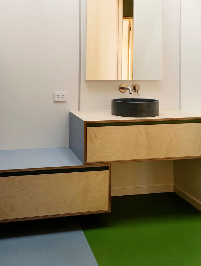 "The downstairs bathroom and laundry have stripes of coloured vinyl, which are playful but relate to function." Gerald shares.