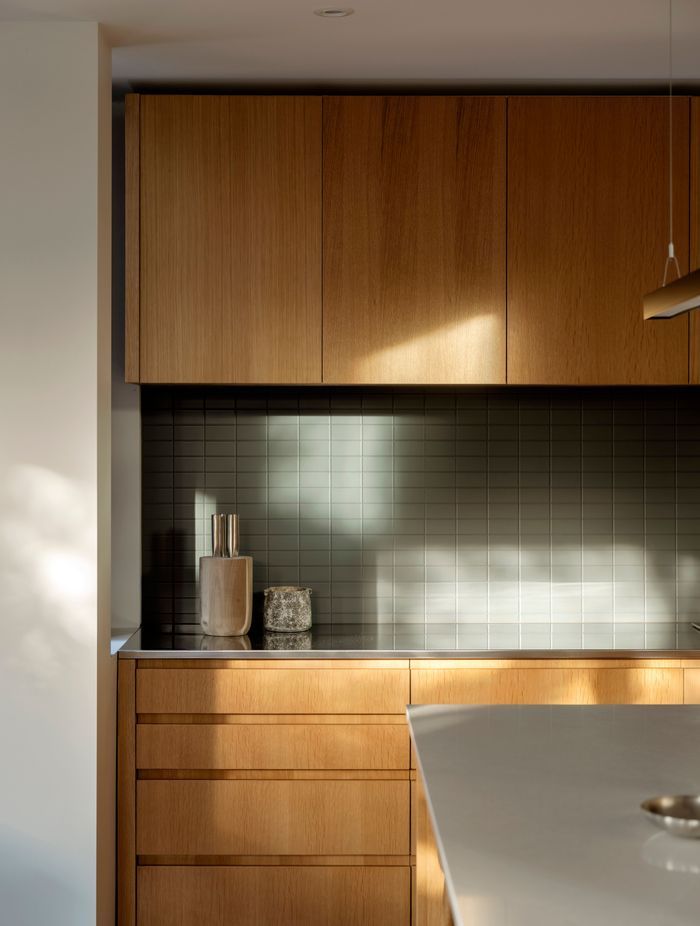 The kitchen receives morning and evening light and is the heart of the open-plan living area.