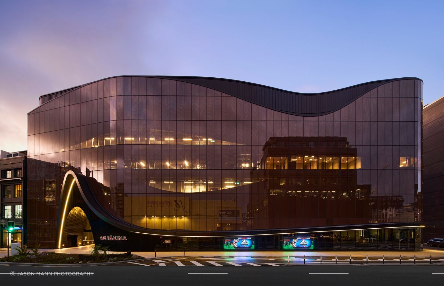 Tākina's Wakefield Street elevation, curving slightly outward into the convex of the street.