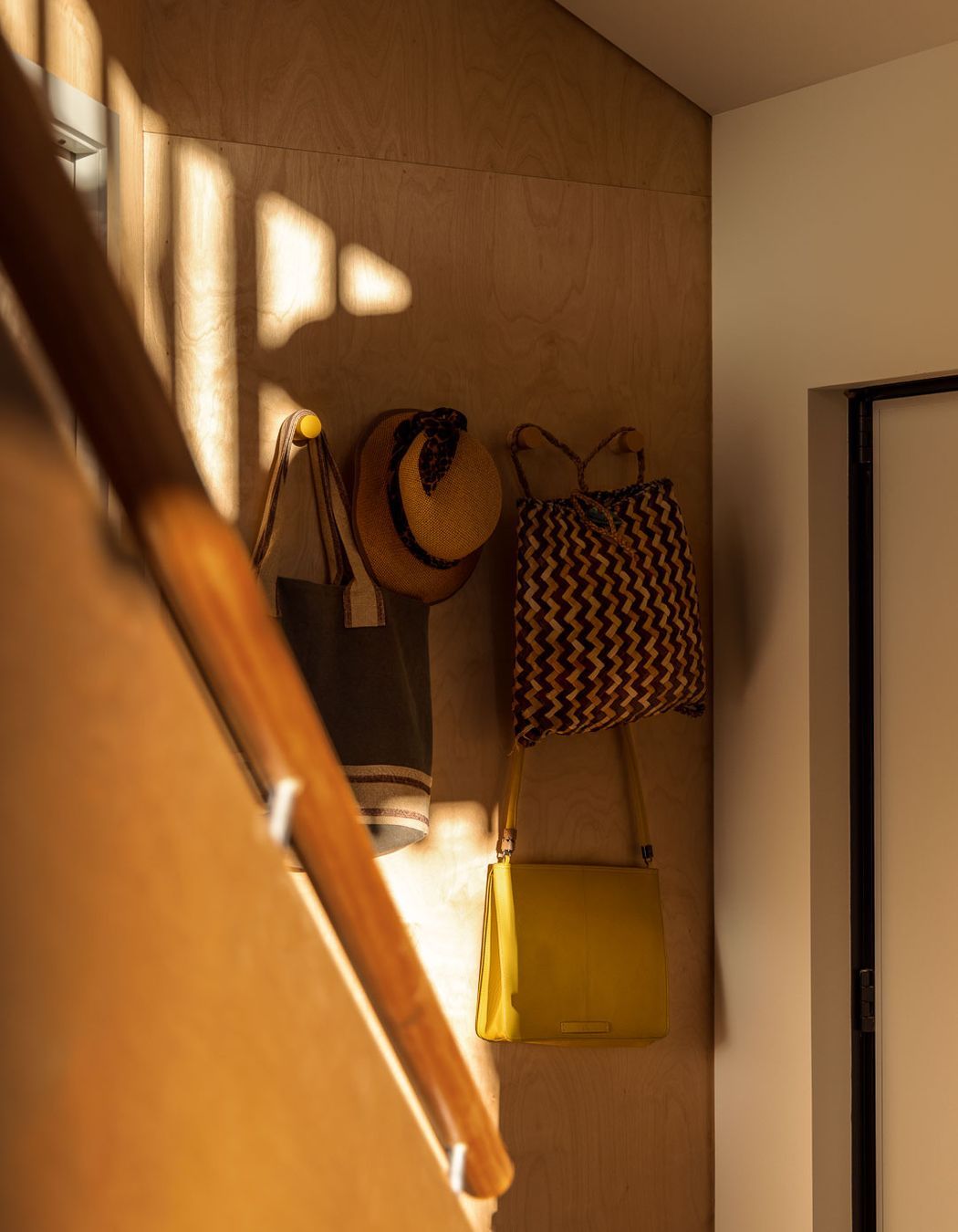 Each space is cleverly appointed a use, including this wall at the bottom of the stairs.