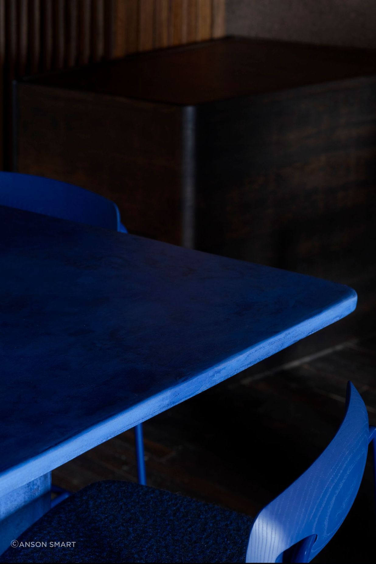 Custom juniper berry blue powder-coated bar stools with dotted Kvadrat/Raf Simons fabric and stained blue timber backrests.