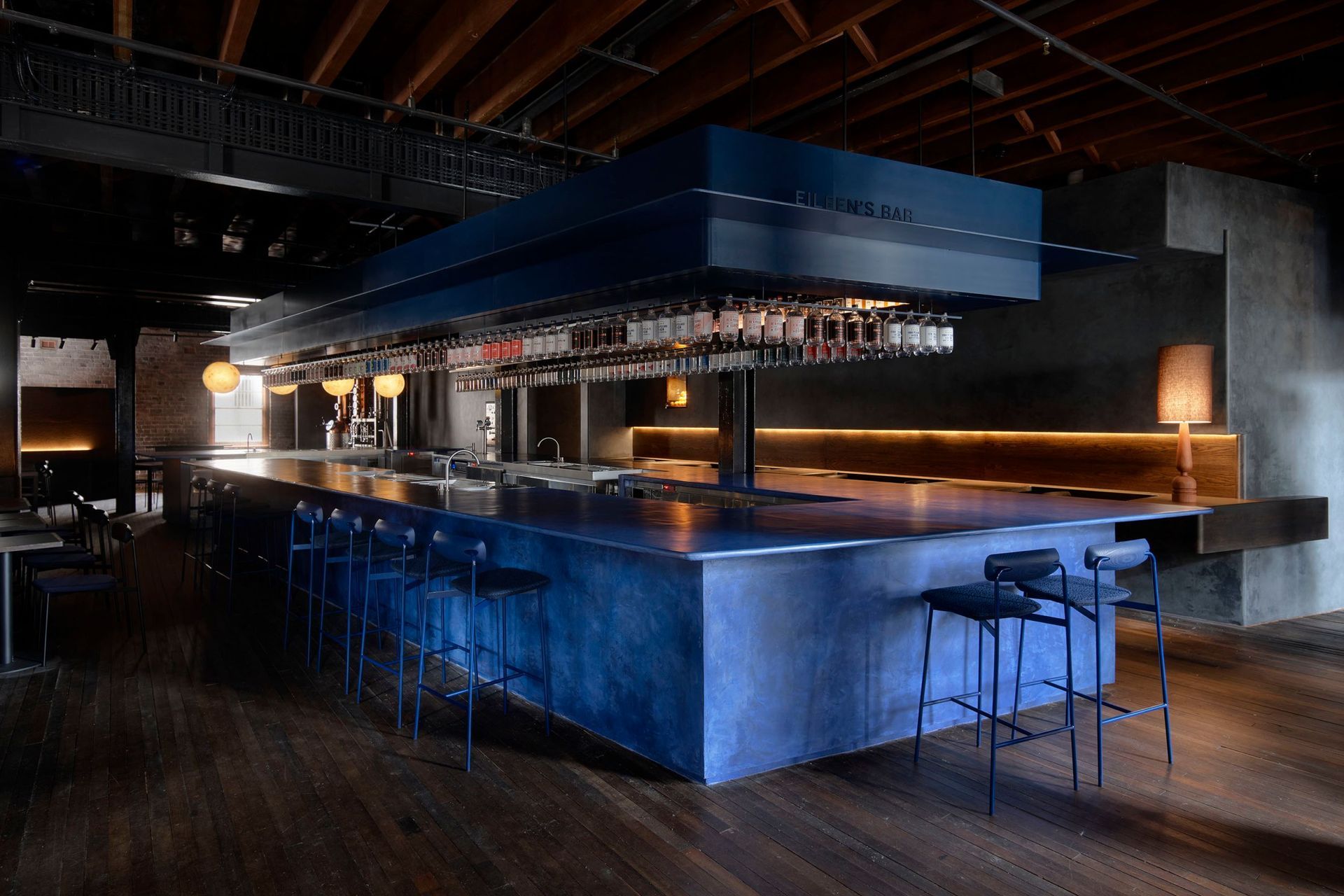 The bar is custom-made micro-cement in a vivid juniper berry blue.