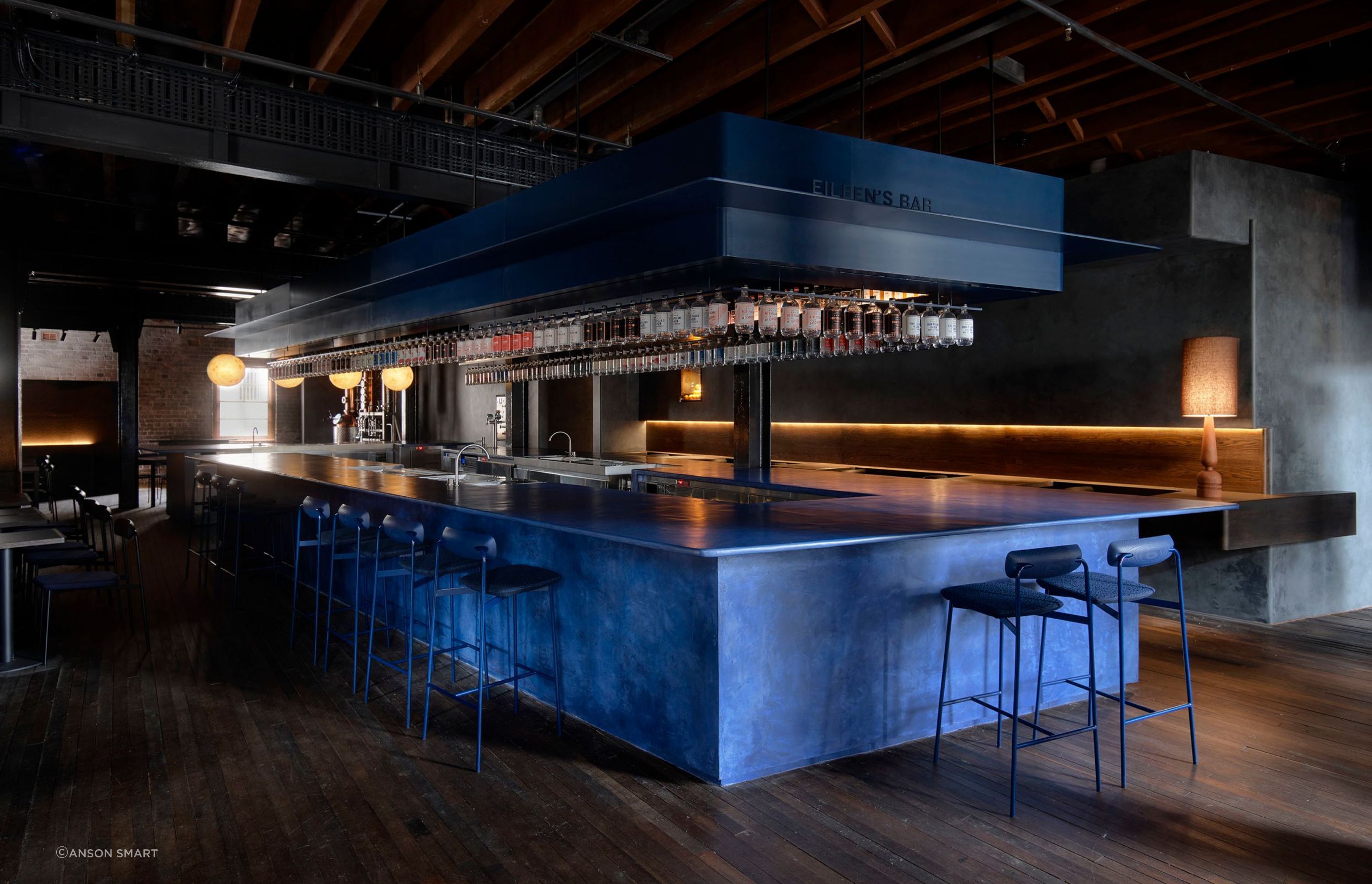 The bar is custom-made micro-cement in a vivid juniper berry blue.