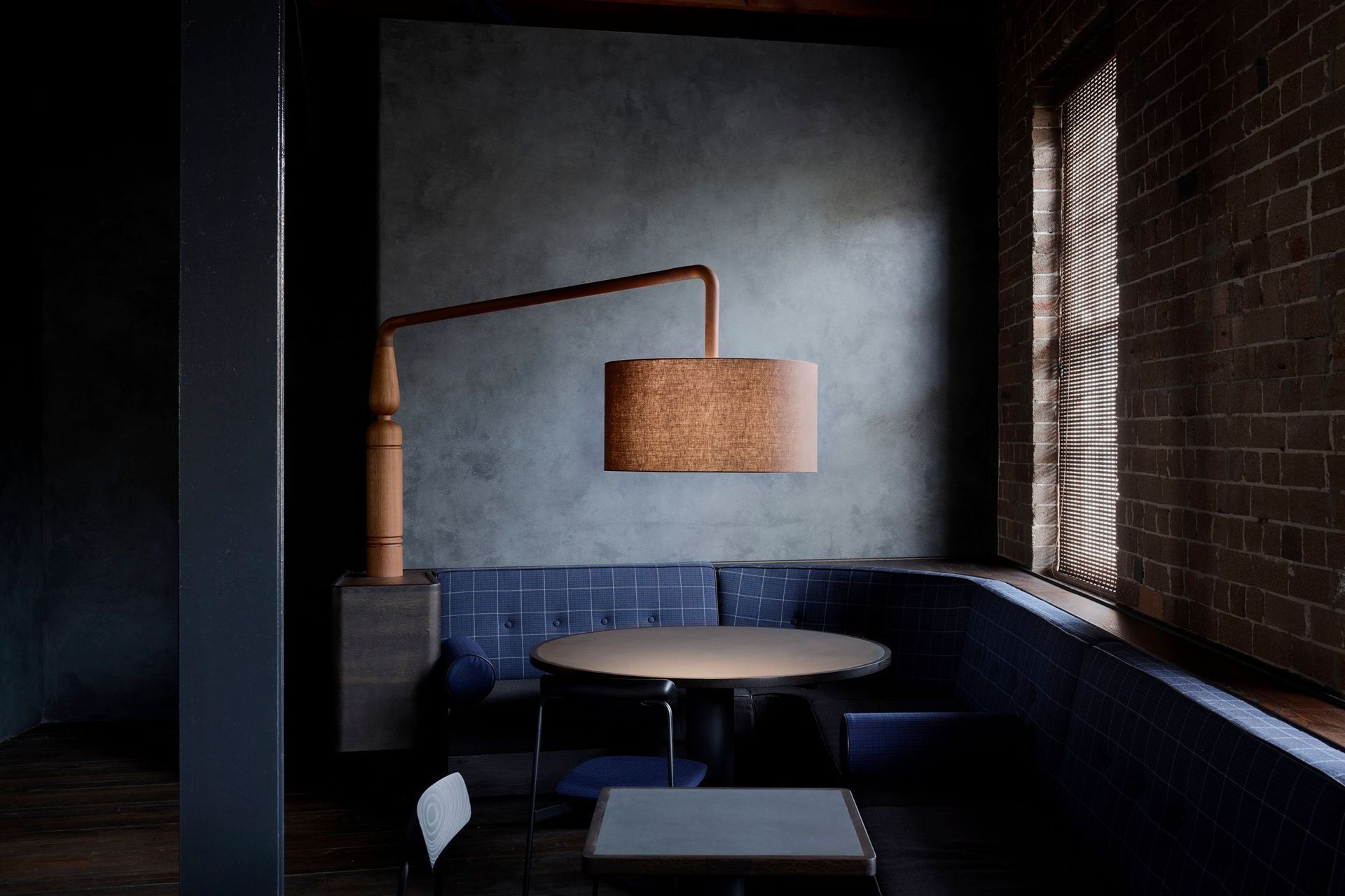 The seating areas are dimly lit with custom timber lamps, each one unique.