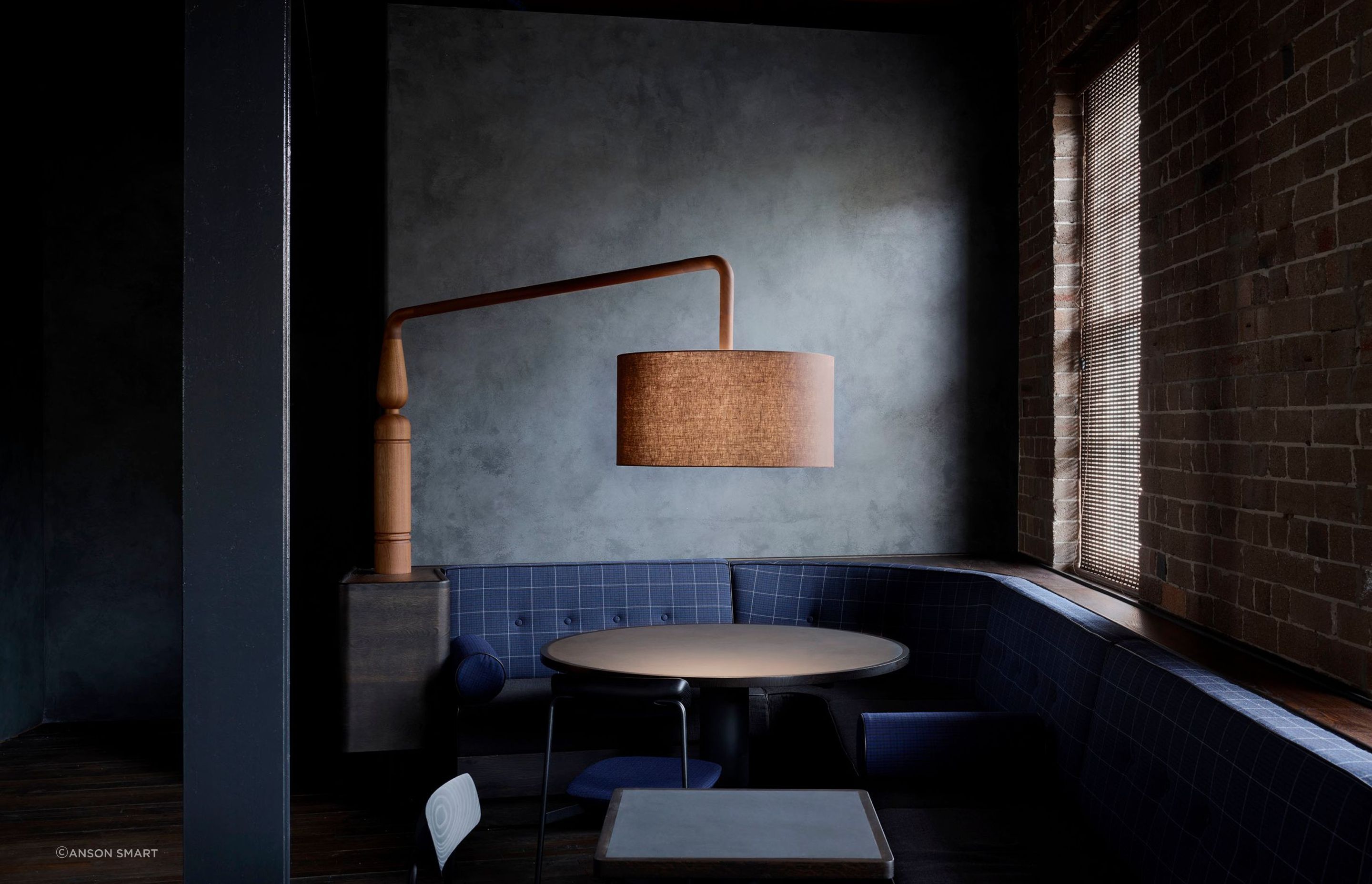 The seating areas are dimly lit with custom timber lamps, each one unique.