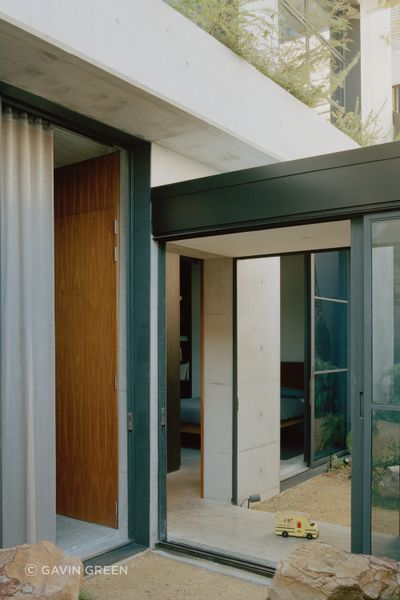 The glazed hallway passes through a courtyard on either side.