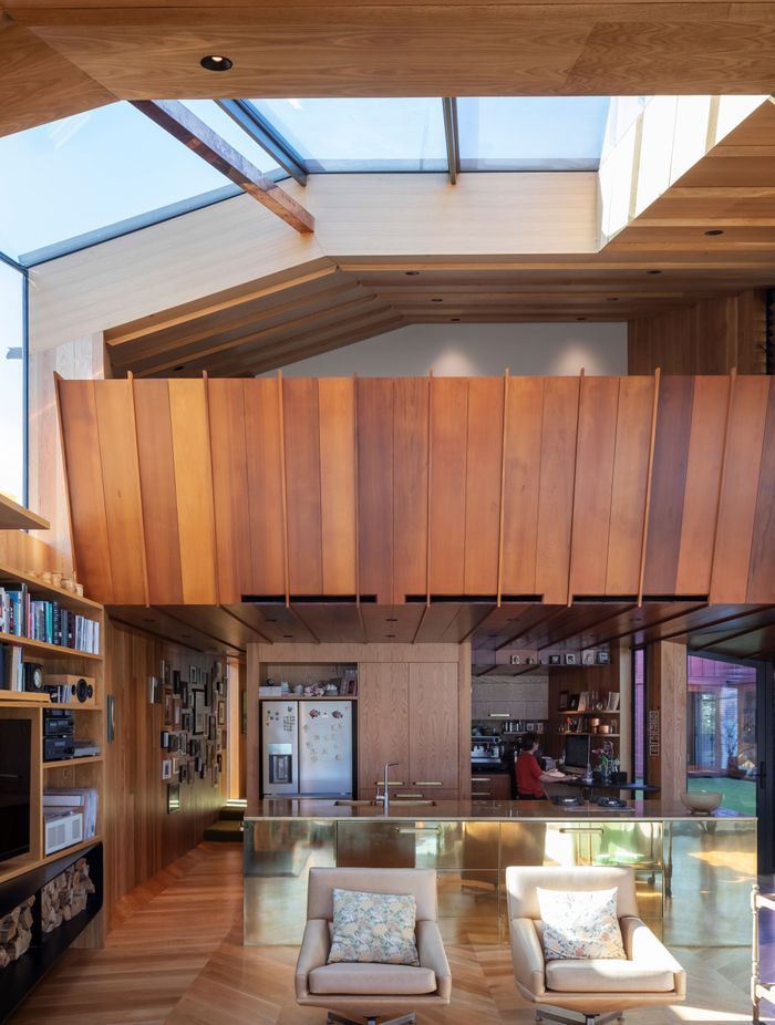 “We wanted something strong within that main living space,” says Brad of the brass kitchen island. “We do the whole thing, the whole process. We design all the cabinetry and joinery, anything that’s built. We drew all the kitchen cabinetry, the built-in furniture, the bench seating in the living room. It’s something we like to do. The home isn’t finished at the shell.”