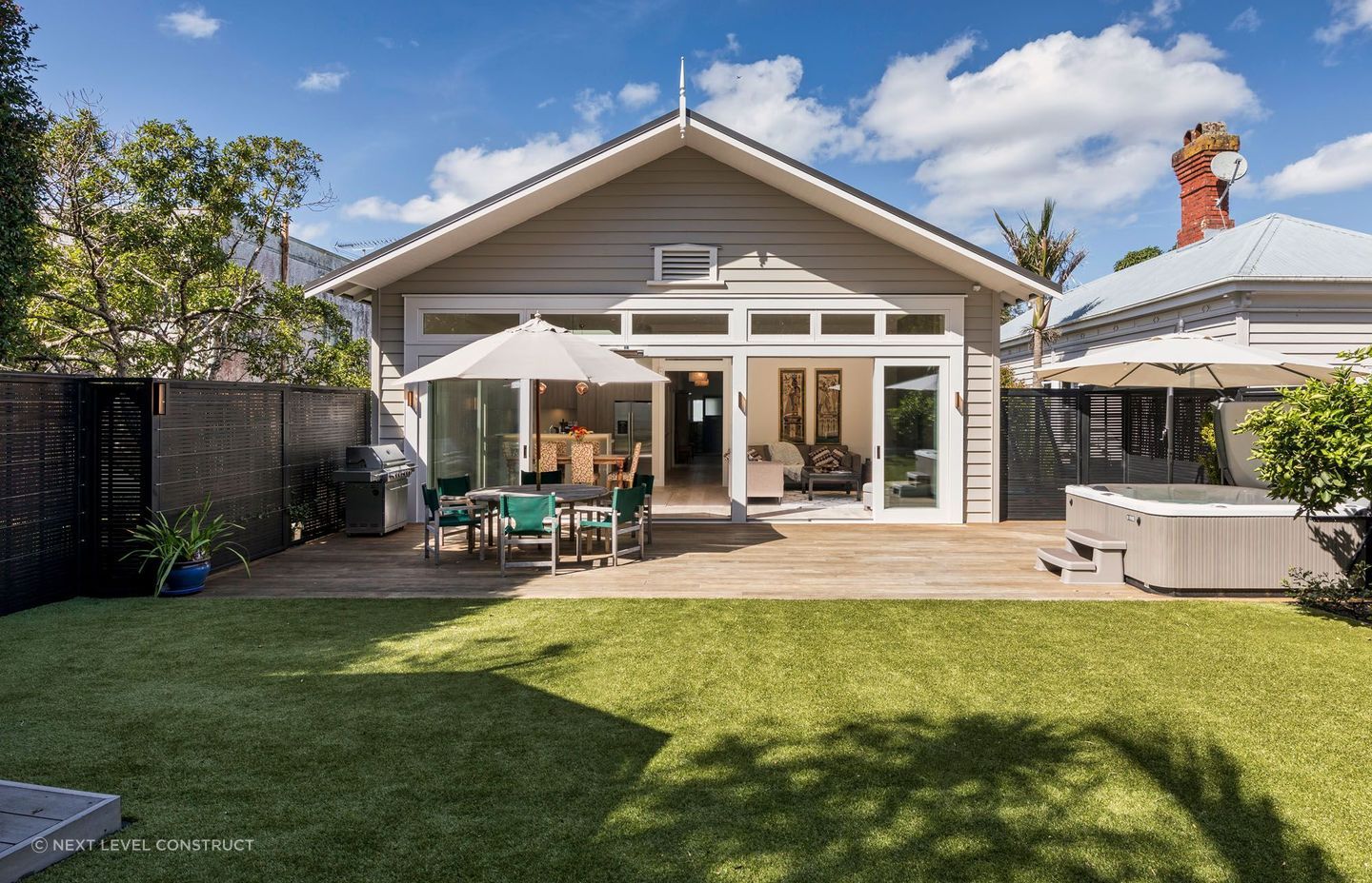 The rear extension complements the villa's original architectural style.