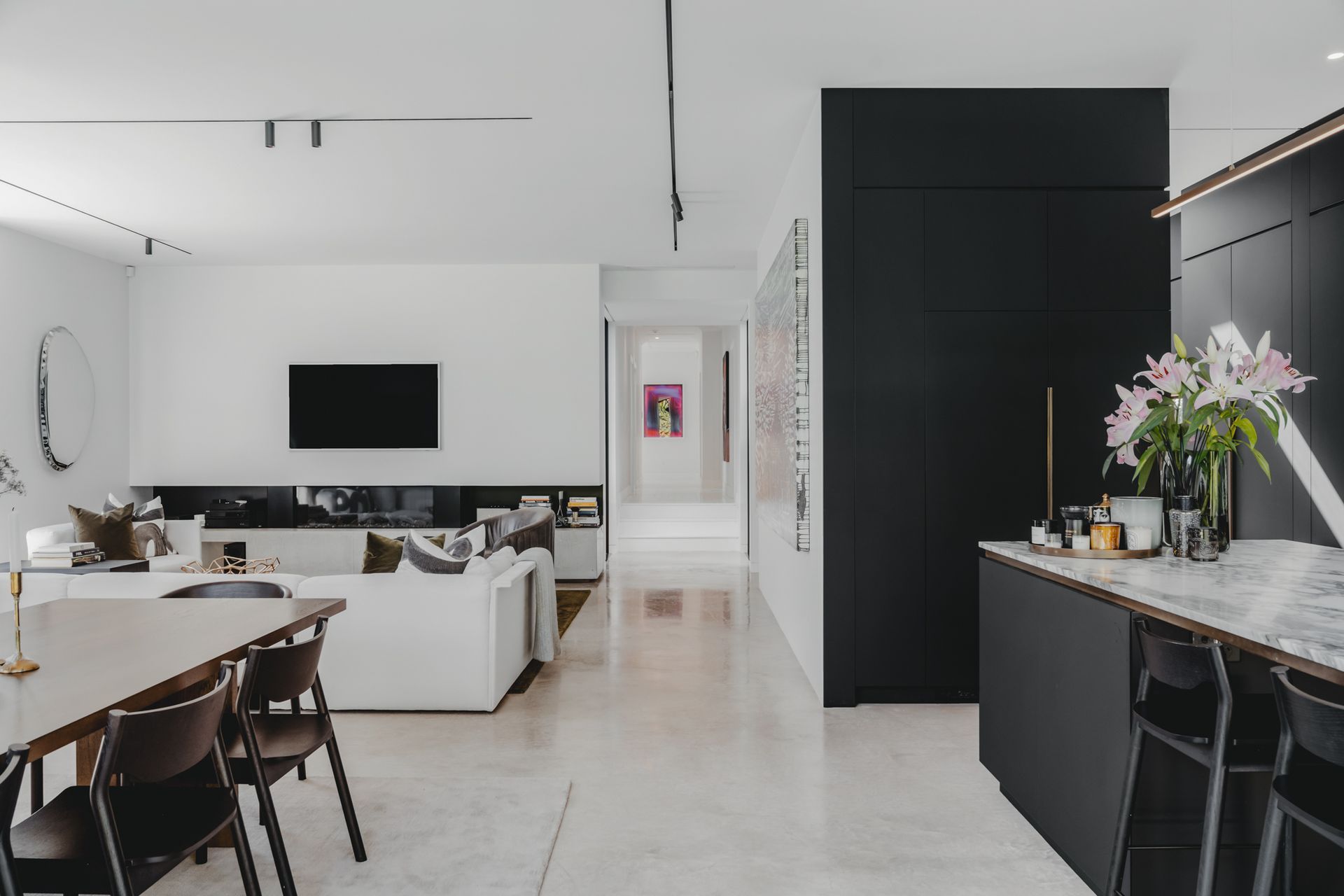 New seamlessly links with the original home through the wide central hallway and a monochromatic palette.