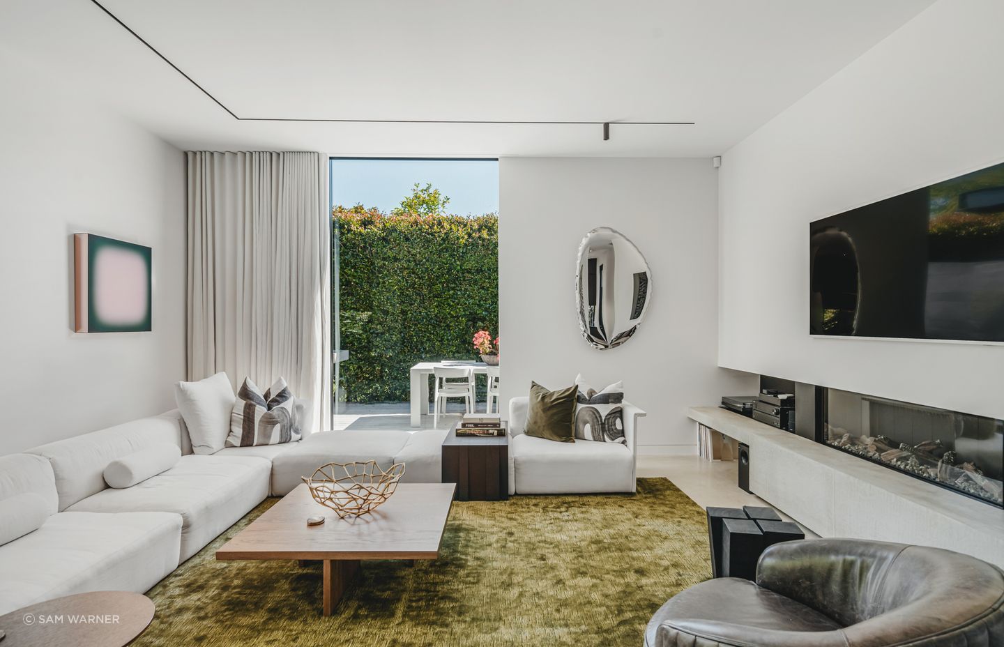 A modern lounge with gas fireplace is part of the new addition, offering a cosy second space.