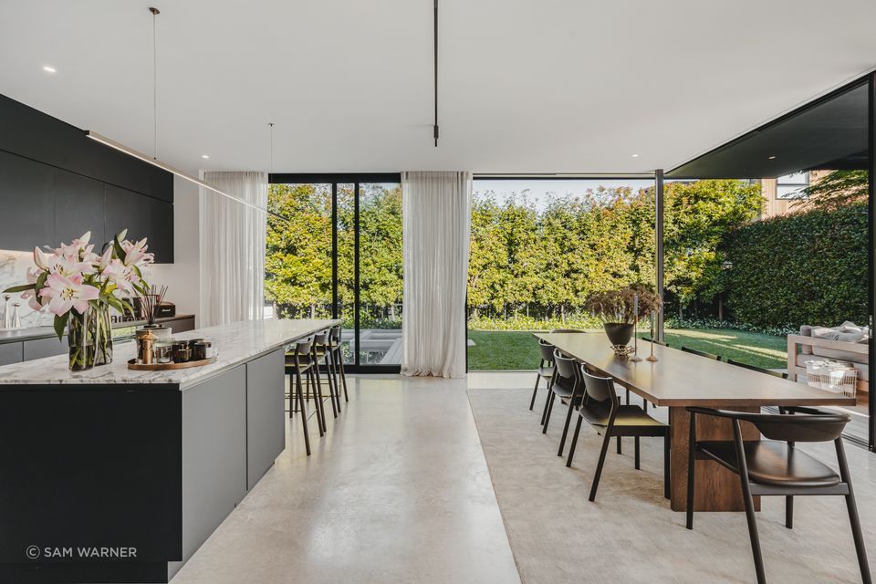 The view of the outdoor living space and pool creates a sense of being at a retreat.