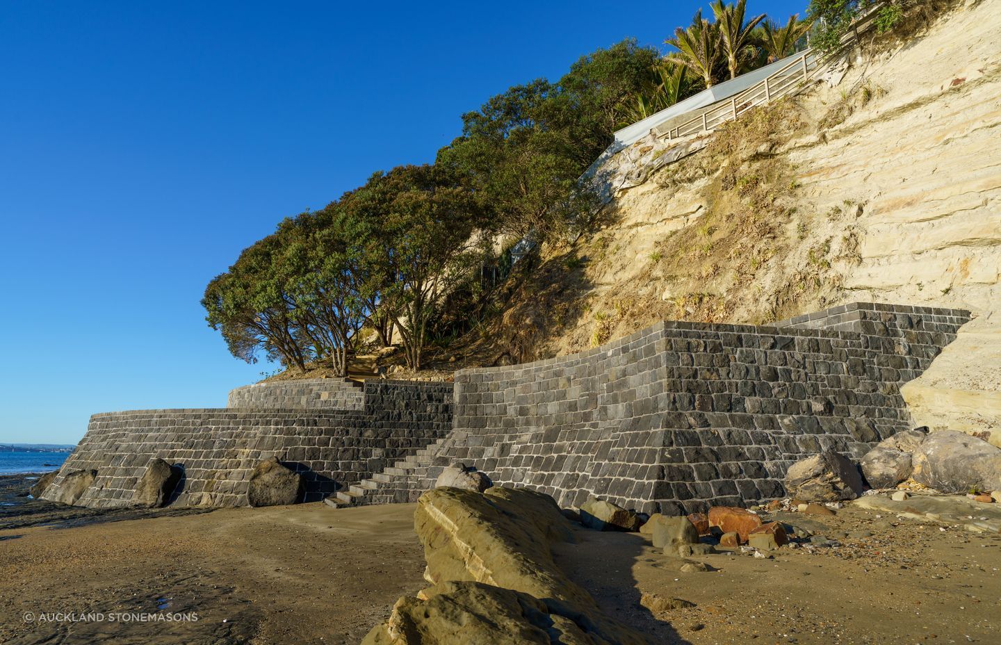 The client was concerned about protecting the pohutukawa trees on his property, engaging Auckland Stonemasons to build a sea wall that would stop them being washed away in the event of a storm.