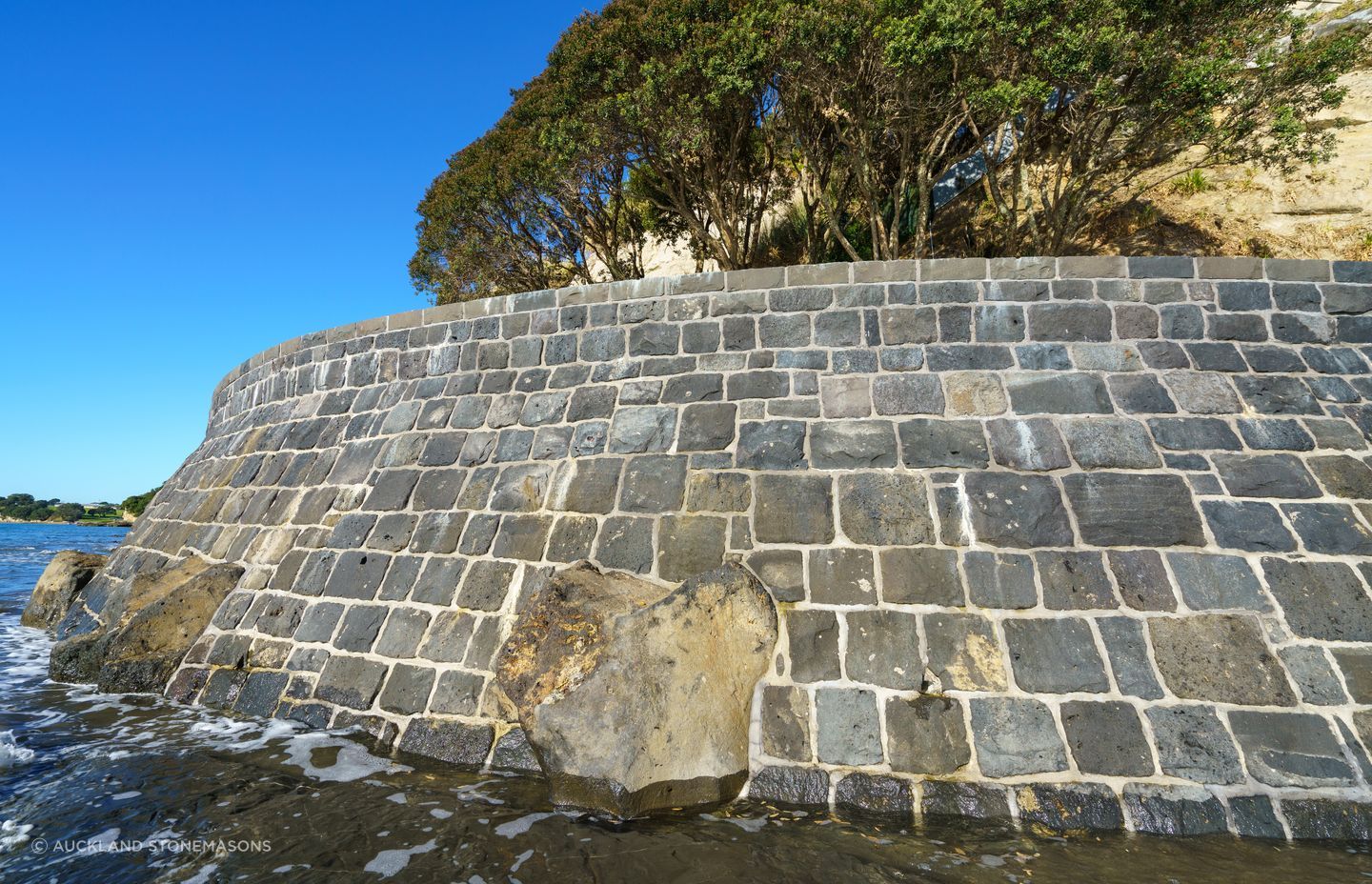 The wall has created a platform for the homeowner to store his boat and swim on warm days.