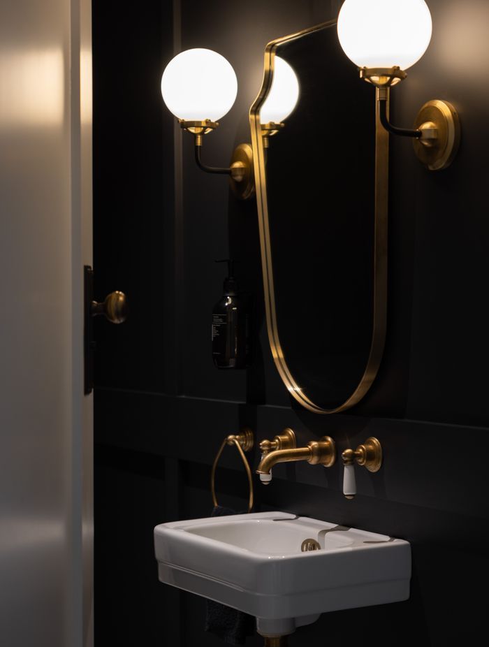 Gold accents add a luxurious feel to the bathrooms.