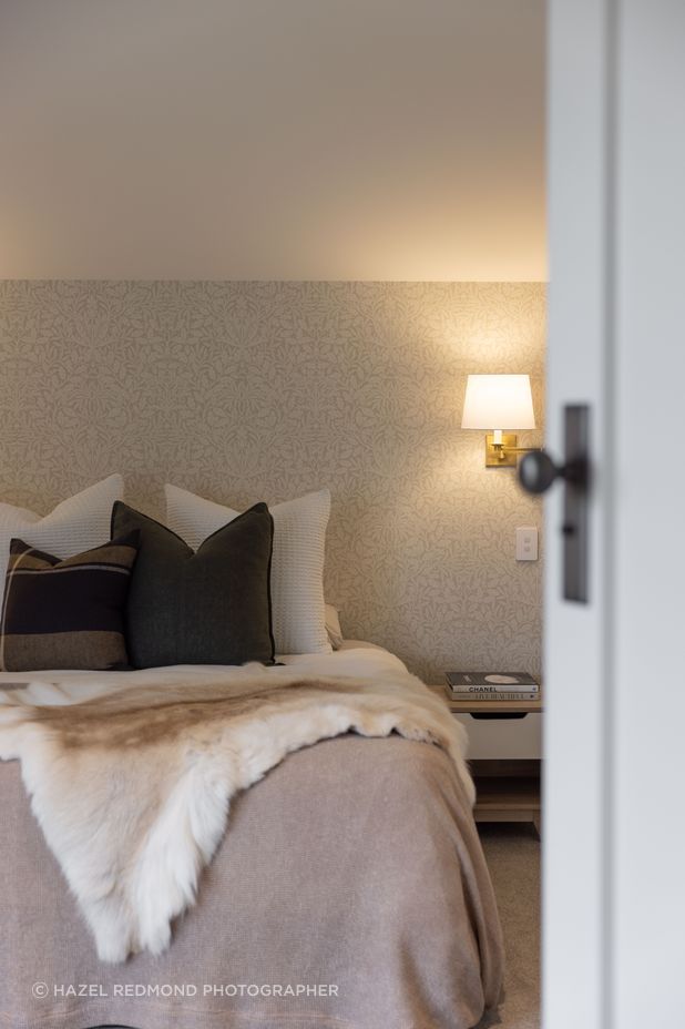 The bedrooms have a hotel-like feel with soft, ambient lighting and elegant wallpaper.