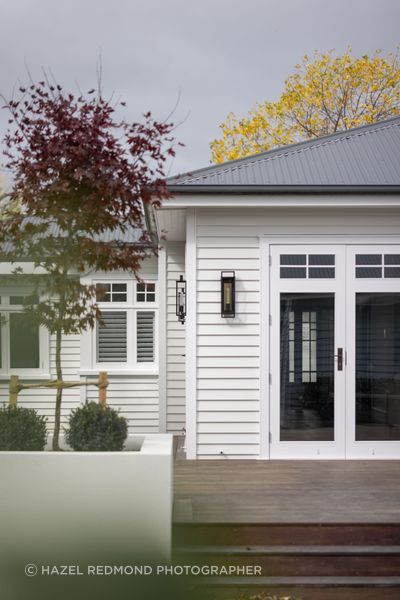 The open-plan living area connects to the deck and backyard through glazed doors.