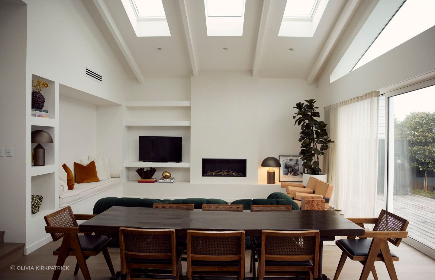 Space was optimised by creating an open-plan cathedral-like room with vaulted ceilings, exposed rafters, and skylights to allow for ample natural light.