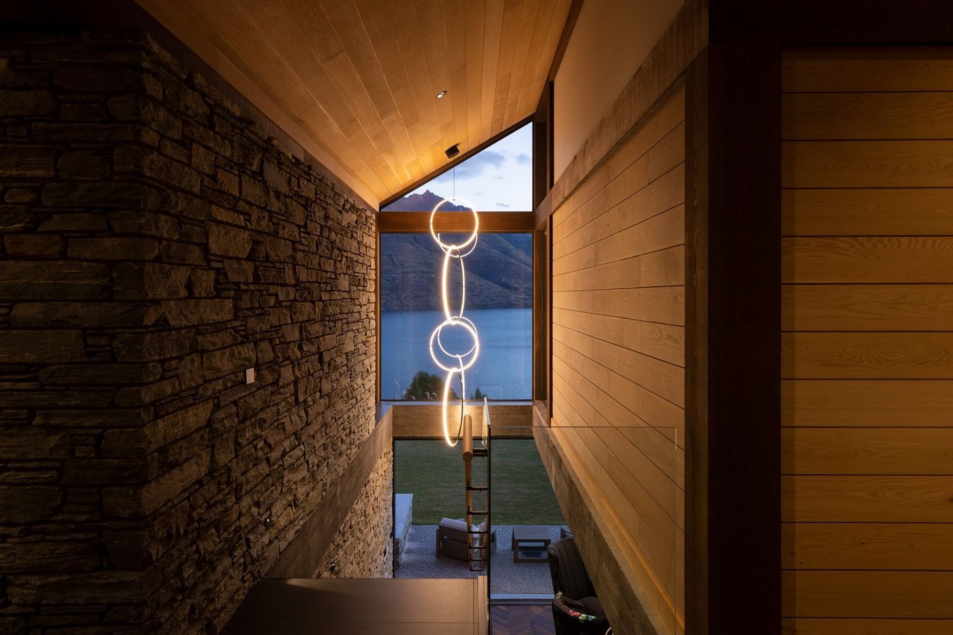 The sculptural Flos pendant light in the stairwell draws your eye out to the view, directly as you enter the main foyer.