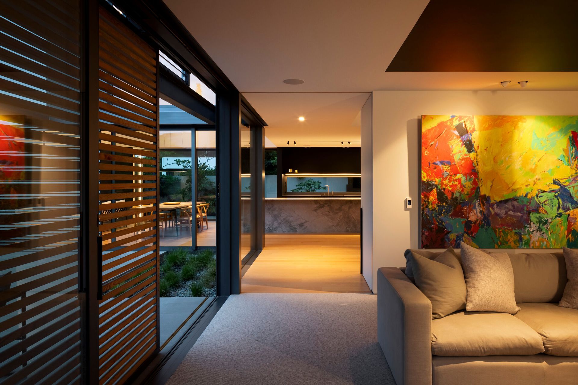 The second living area is the 'den', a more intimate space with a lower ceiling, dark walls and blinds, and warm wool carpet to hunker down in the evening.