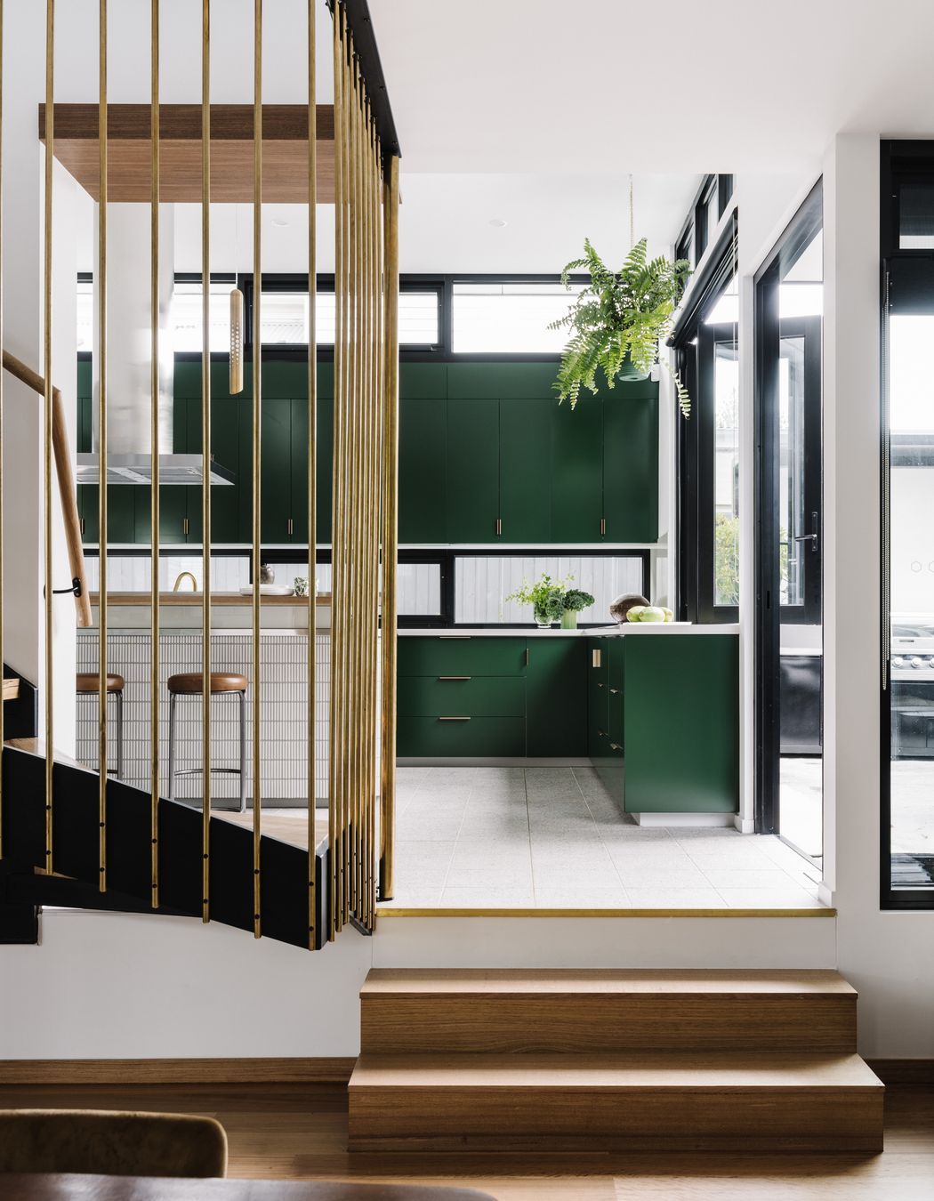 Stepping up from the living and dining, the kitchen floor features beautiful Promenado terrazzo tiles from Beaumont Tiles.