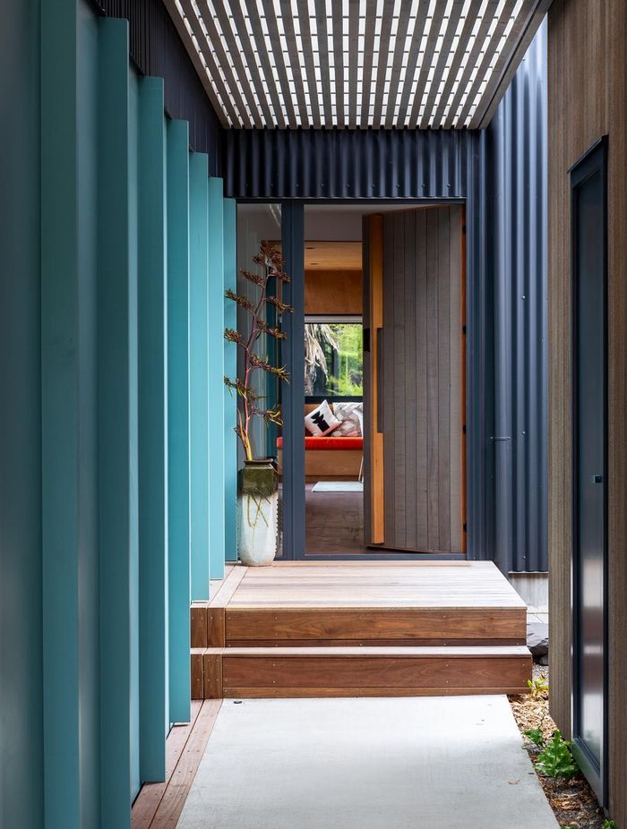 The boardwalk approach to the main front door passes underneath the upstairs apartment. There is a courtyard next to the front door. “As you walk down the restrained boardwalk, there is a sense of release as you get to the courtyard and go in the front door,” says Gerald.