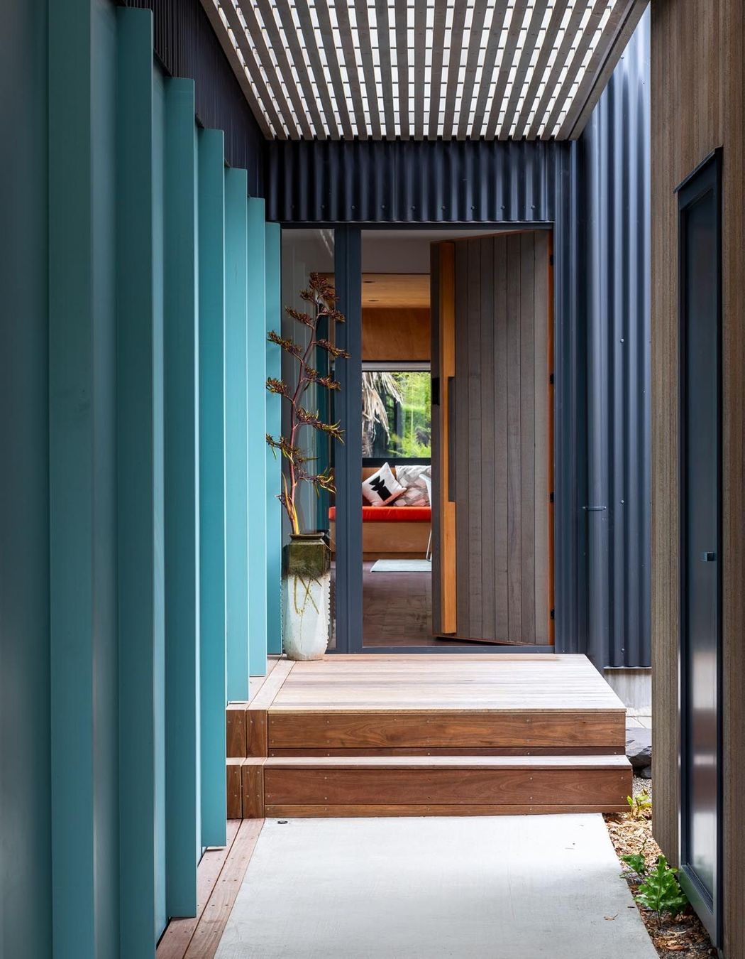 The boardwalk approach to the main front door passes underneath the upstairs apartment. There is a courtyard next to the front door. “As you walk down the restrained boardwalk, there is a sense of release as you get to the courtyard and go in the front door,” says Gerald.