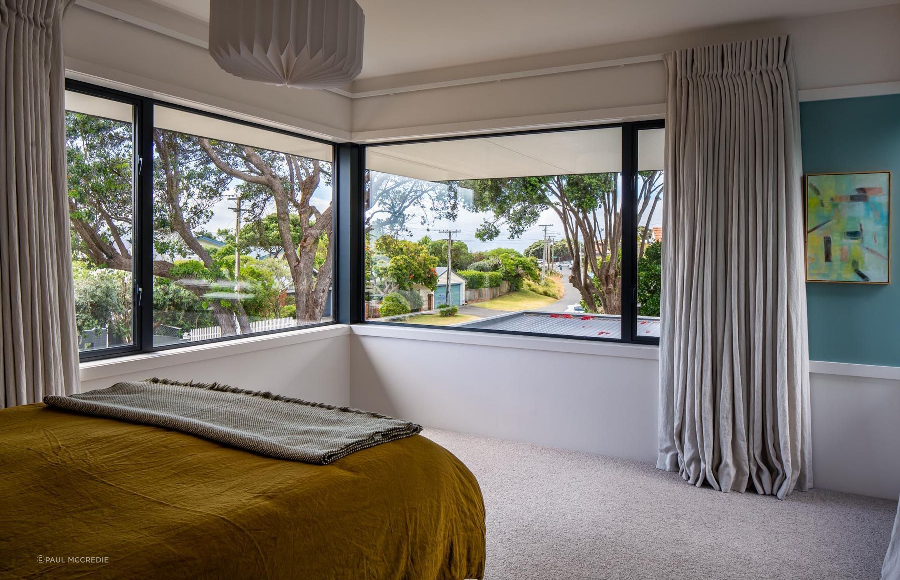 An existing pōhutukawa tree is on the corner of the property. “The master bedroom looks through the pōhutukawa tree out to the street, which is quite pretty.”