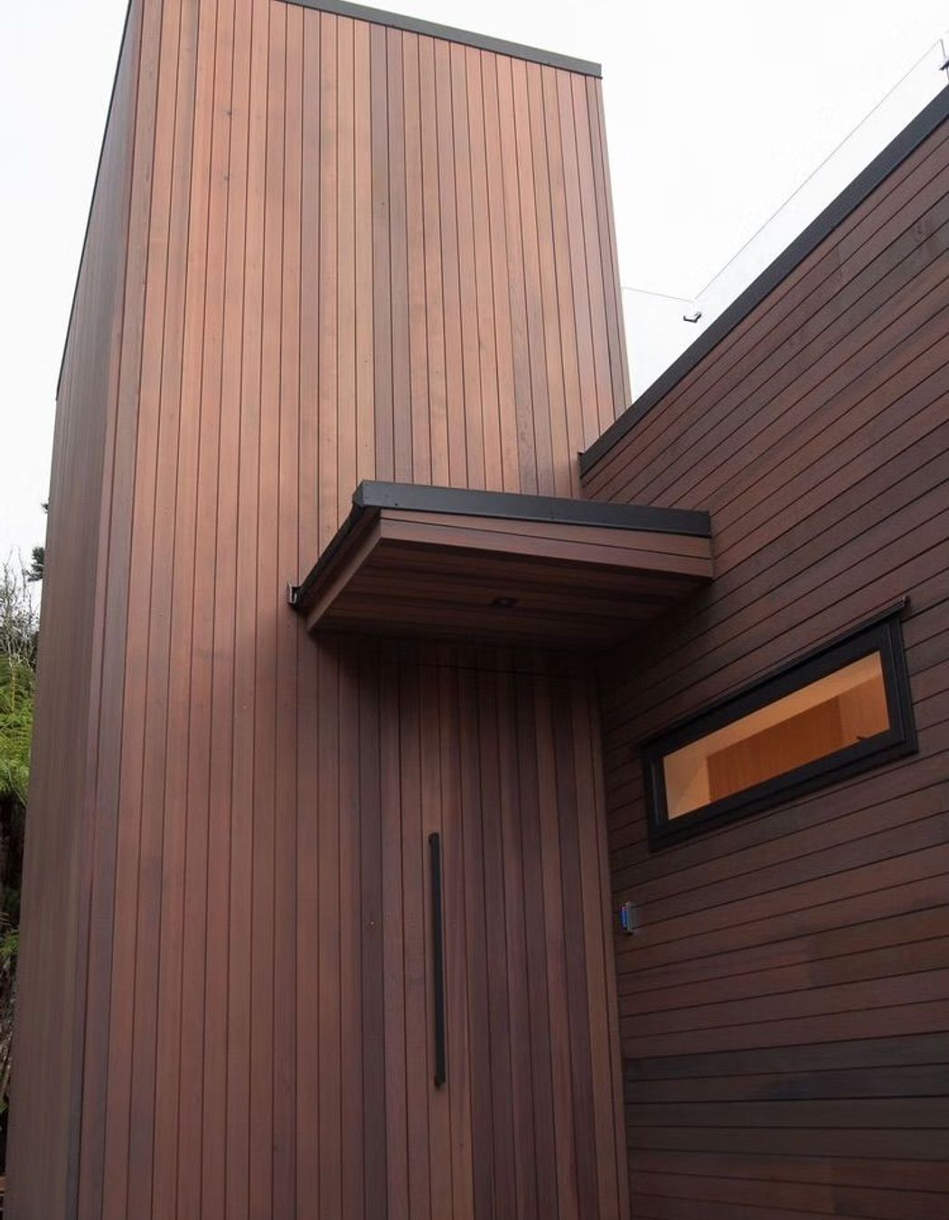 The cedar cladding blends in with the rich browns and greens of the surrounding bush, complementing the land rather than distracting from it.