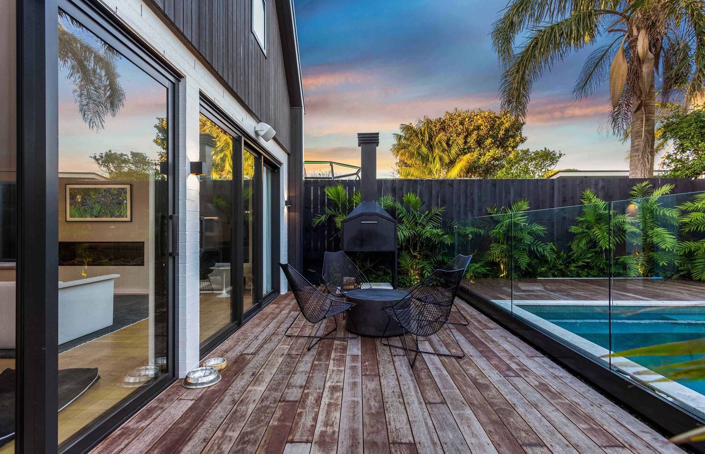 An outdoor living space is tucked neatly between the living space and pool, and allows seamless flow from indoors to outdoors.