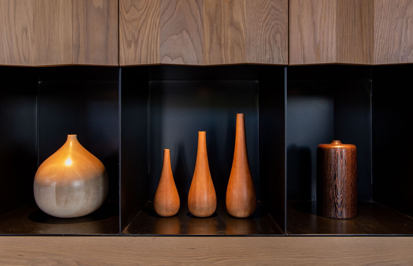 The turned wood samples are highlighted by recessed lights in the cabinet. Image Ross Keane