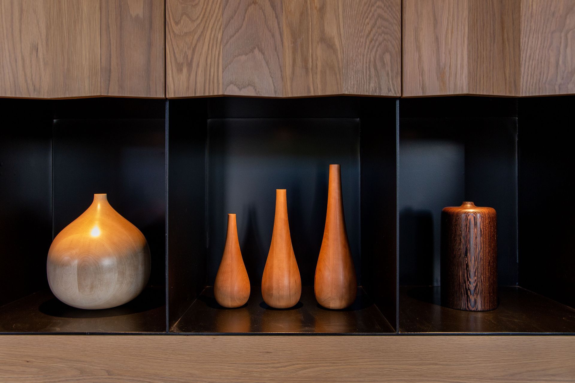 The turned wood samples are highlighted by recessed lights in the cabinet. Image Ross Keane