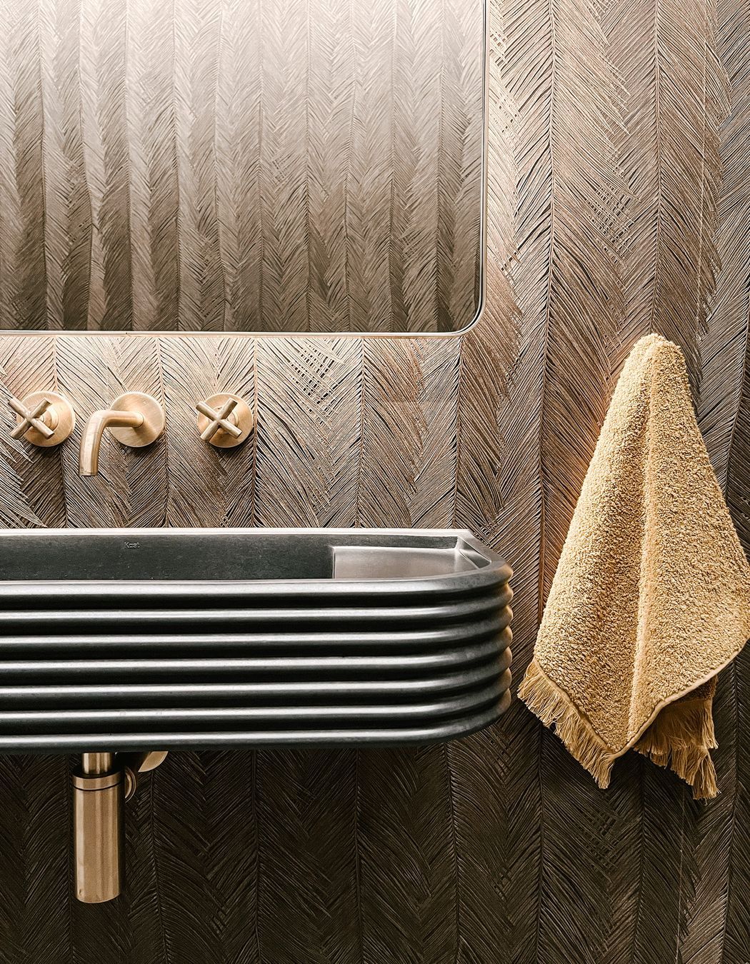 The wall-mounted Chap tapware in brushed brass is from Plumbline. “I love the dark colour with the brass.”