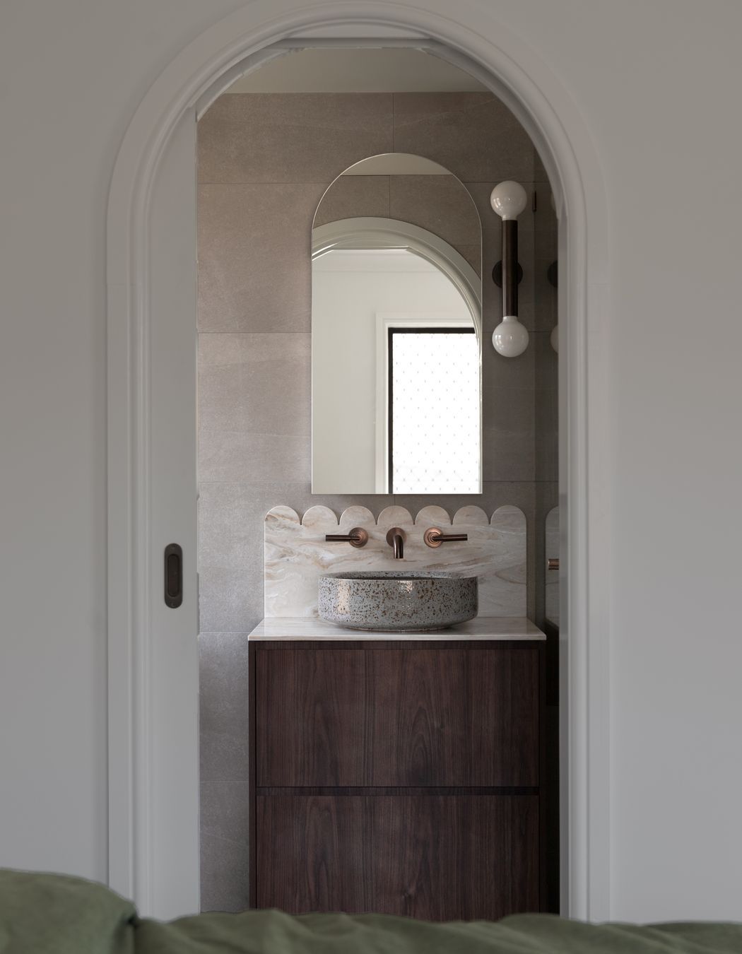 The ensuite features a scallop Corian detail, cut by the team at Best Kitchens.