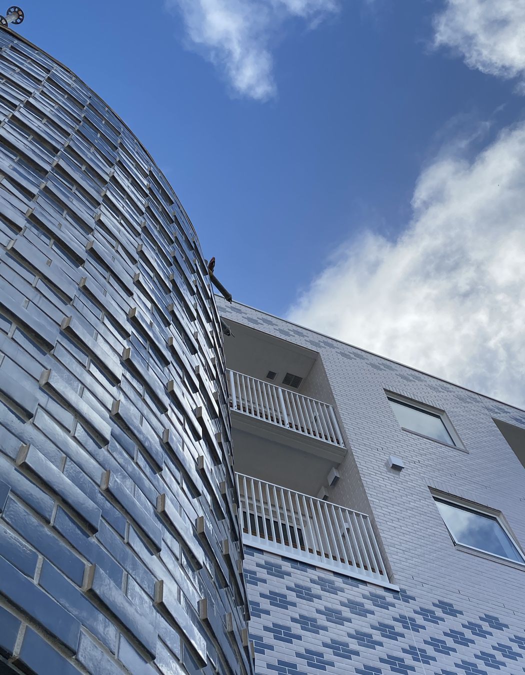 Work in progress photos show the playful expression of pattern and colour through the brick façade.