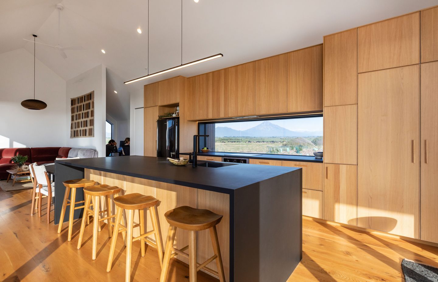 The main dwelling’s beautiful oak kitchen, with an expansive view of Mount Taranaki. | Photographer: Sandra Henderson