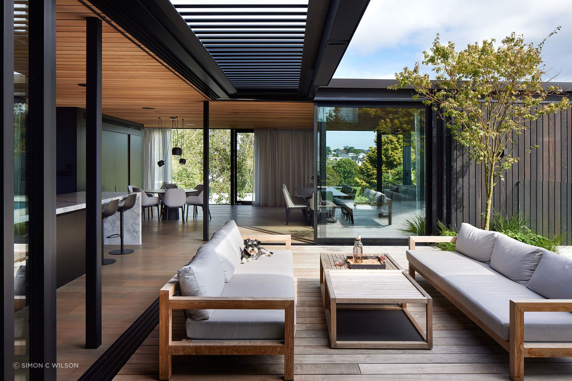 Blurring the lines between indoors and out, the outdoor entertainment area is a direct extension of the interior kitchen, living and dining.