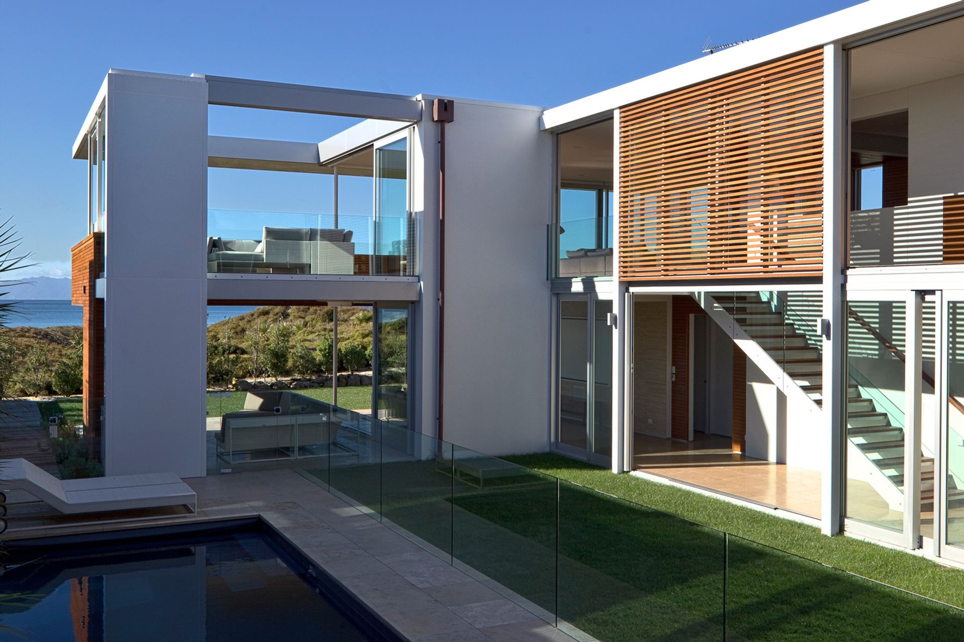 The clever layout of the home brings an immaculate lawn and swimming pool closer to the living spaces. | Photography: Patrick Reynolds