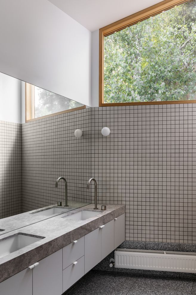 High windows provide privacy while welcoming light and views into the ensuite.