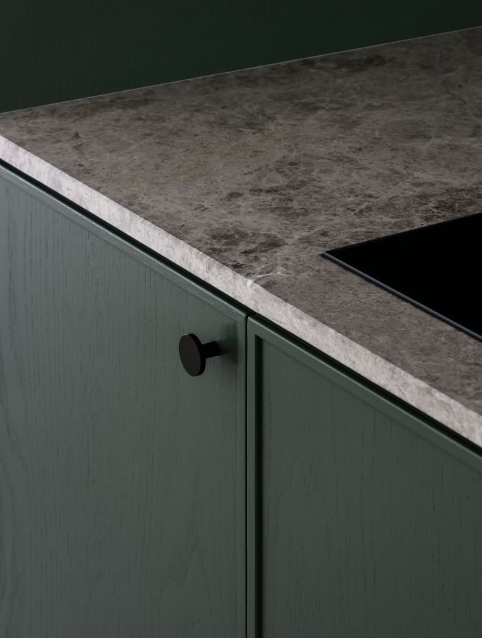 Wood grain cabinetry and marble bench tops add interest and texture.
