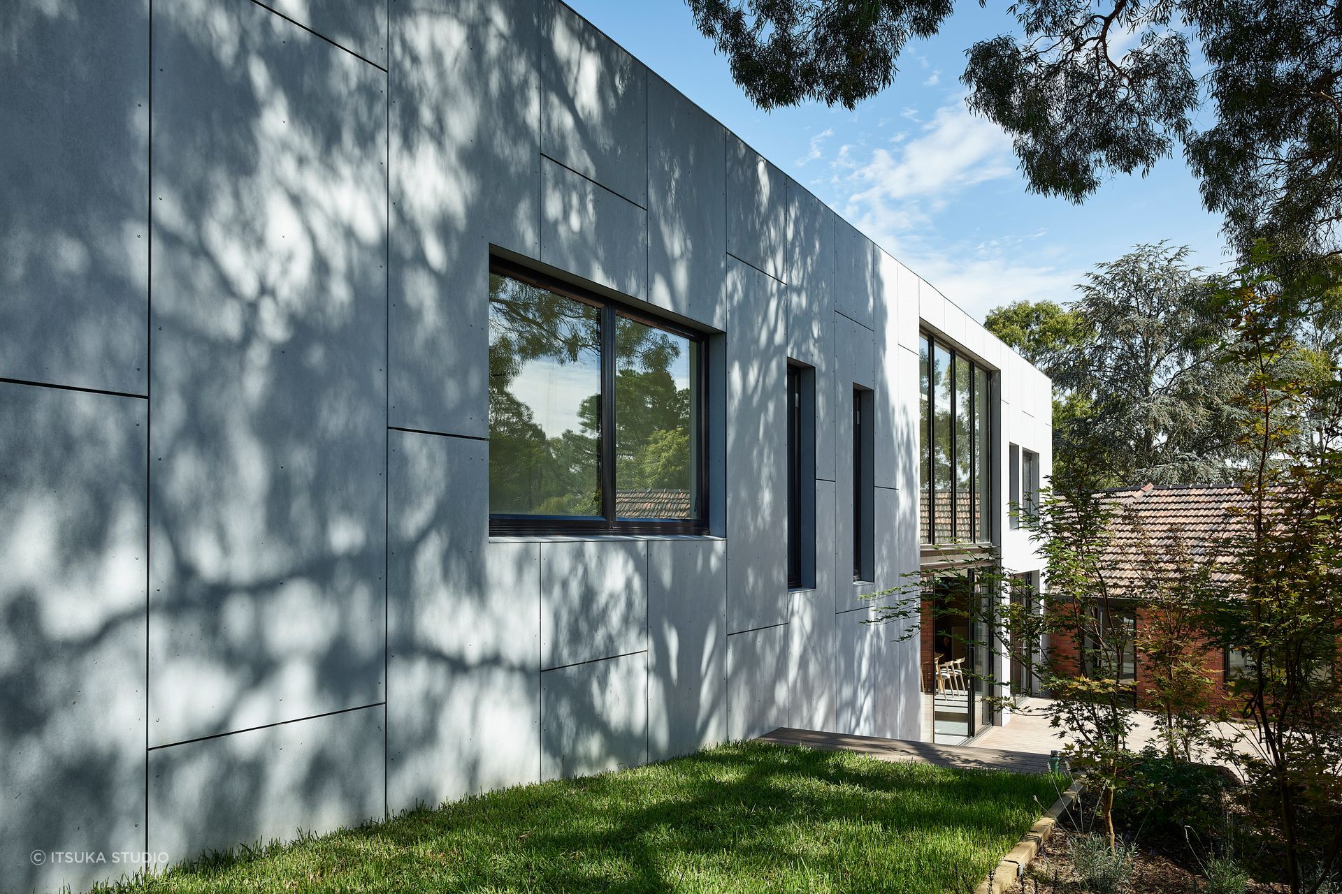 From the original brick home, the extension starts as two storeys – becoming a single level as the site slopes upwards at the back of the property.