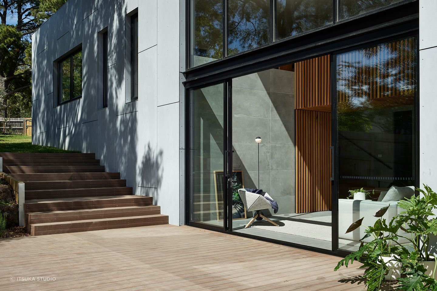 Floor-to-ceiling glazing connects the outside and in, with the deck an extension to the living area.
