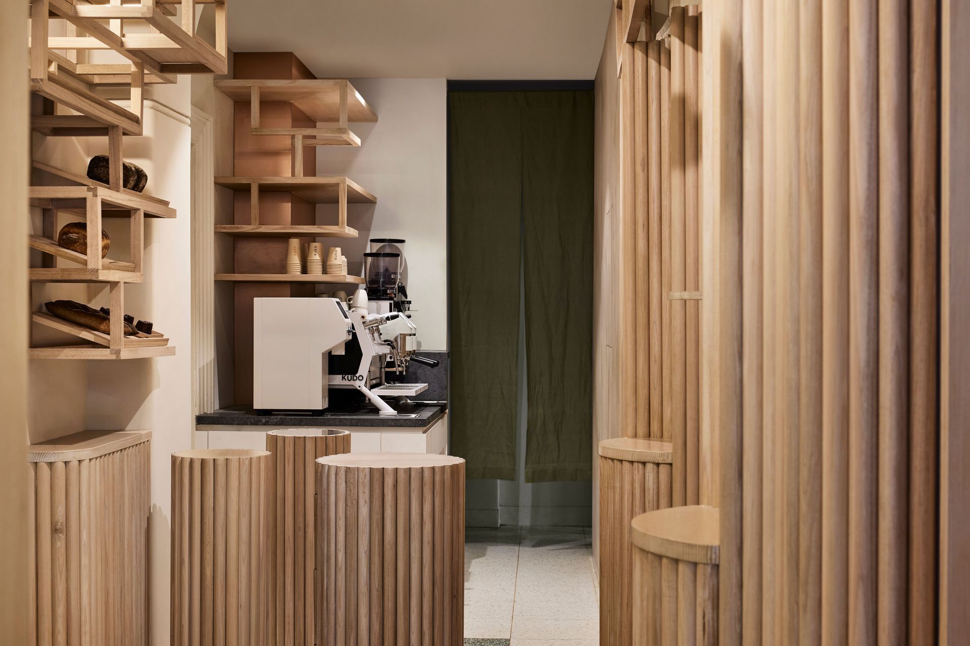 "Canelé-inspired furniture sits on the ground plane, guiding people around the narrow space. The pieces create organic traffic movement, similar to a sculptural garden."