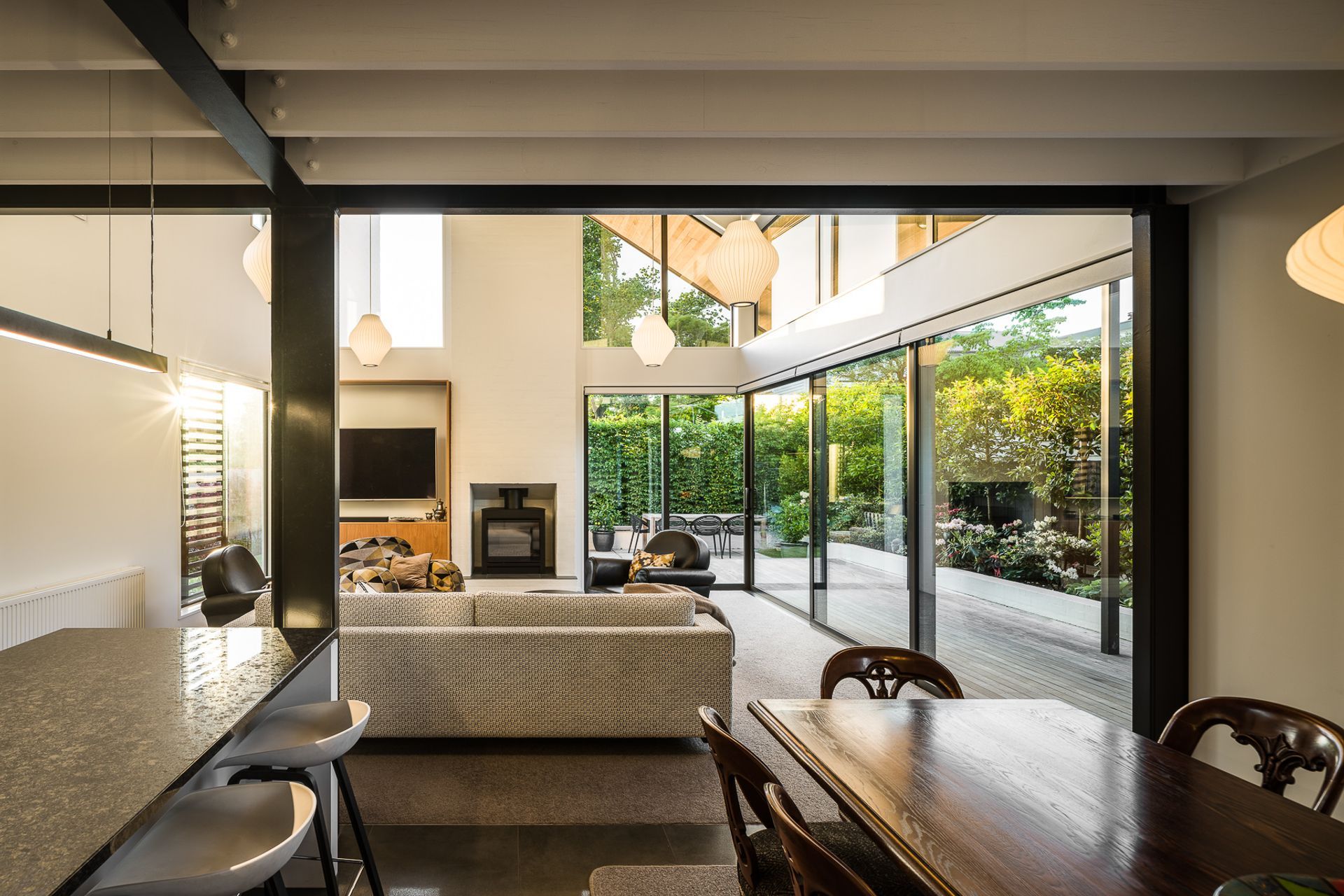 The living area with the kitchen and dining area on either side, looking from the main hallway.
