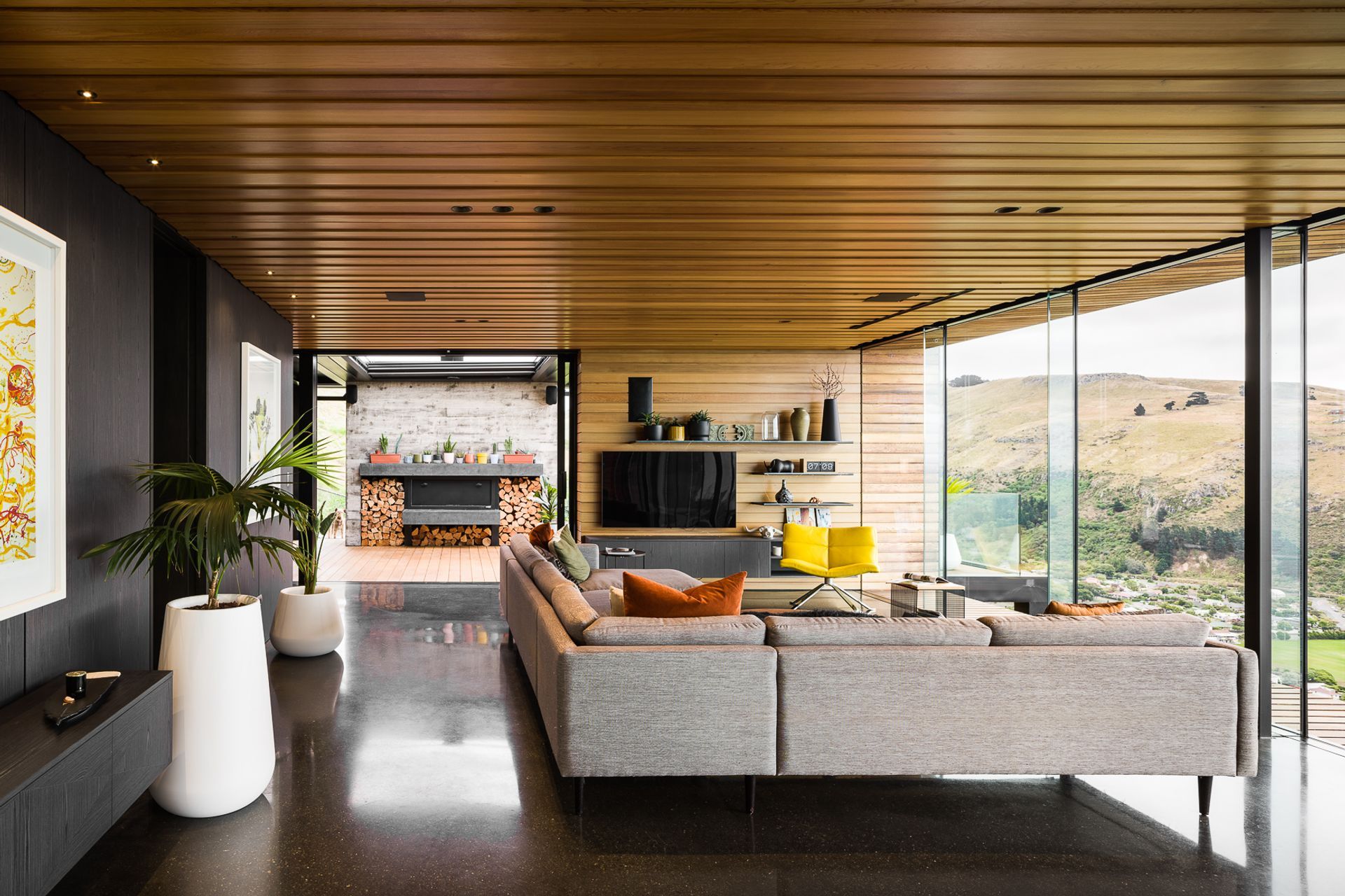 The open-plan living space leads directly to the outdoor living space through floor-to-ceiling sliders.