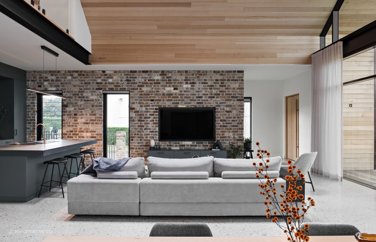 The New York loft references combine black metal, brick, and timber-lined ceilings.