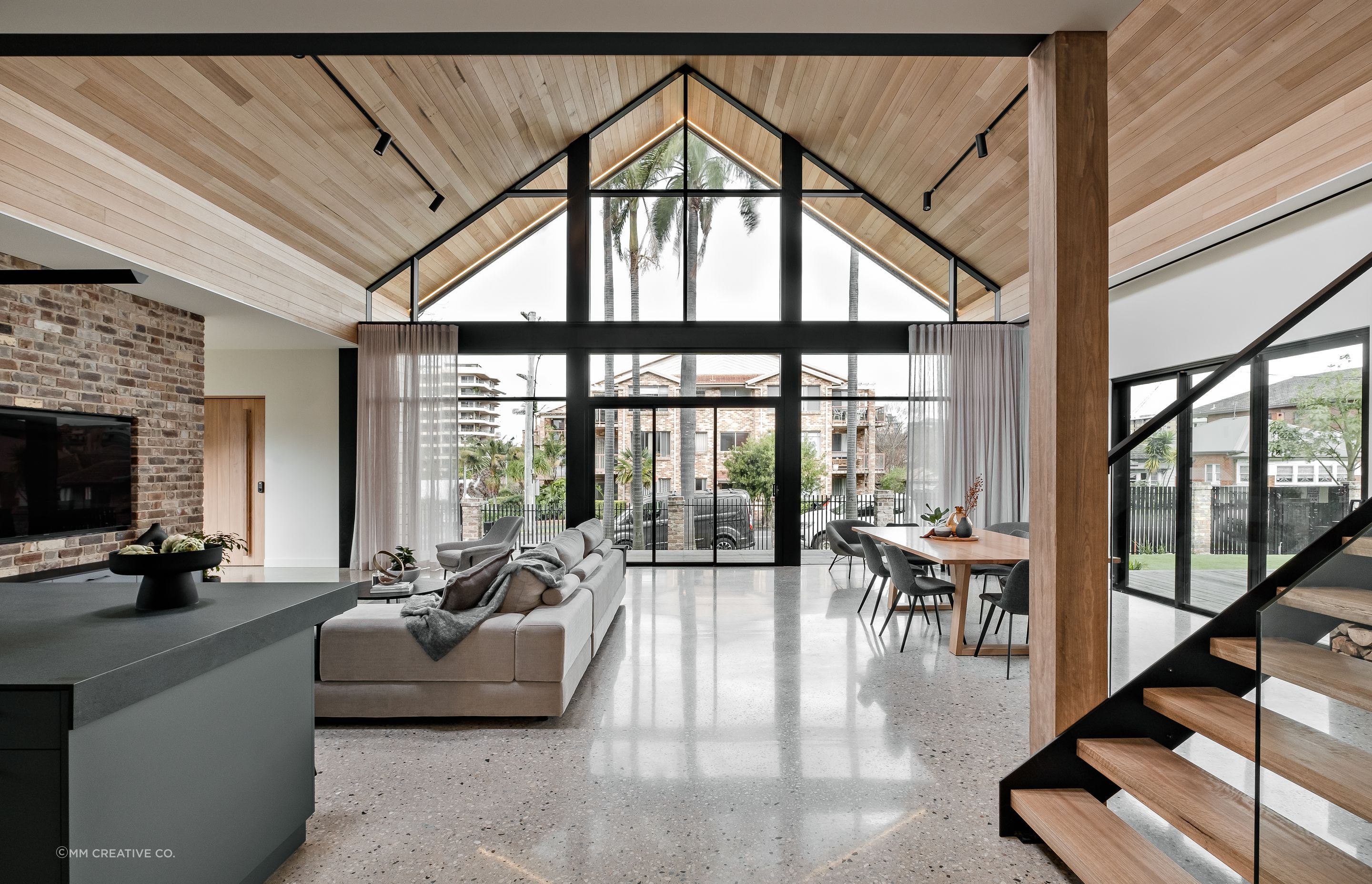 The timber lining on the ceilings is carried outside into the soffits; the simple A-frame architecture allows the materiality to take centre stage.