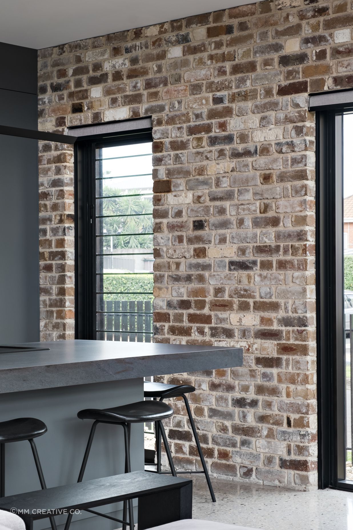 The recycled brick facade is carried through one wall of the interior.