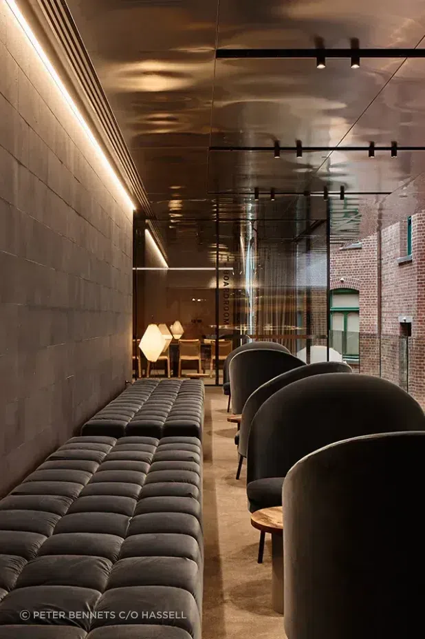 An anti-space off the boardroom with a B&B Italia Tufty-Time sofa and Jim armchairs by Arflex, offset by the textural warmth of the surrounding heritage buildings.