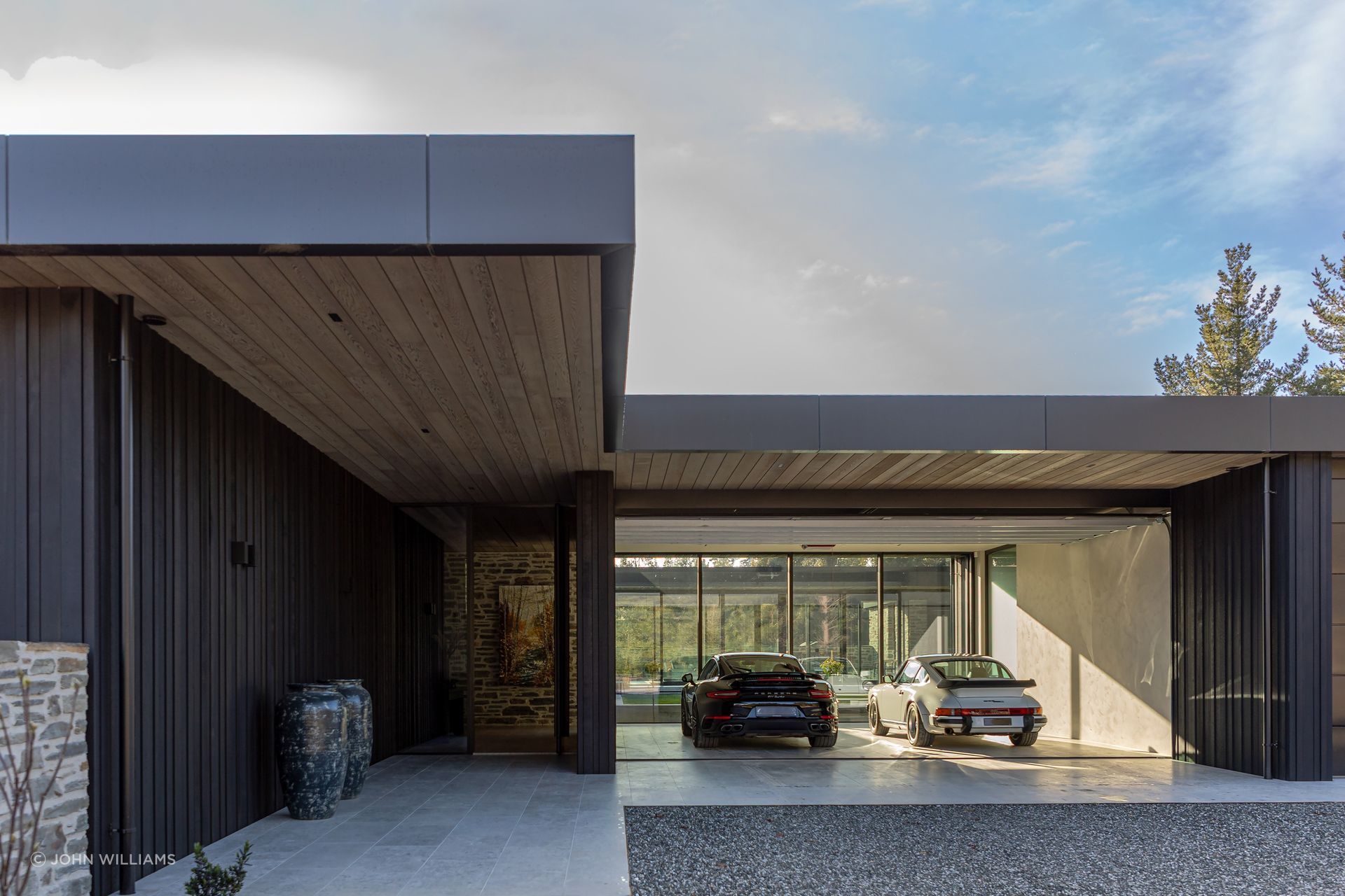 The glazing in front of the garage turns it into a car gallery.